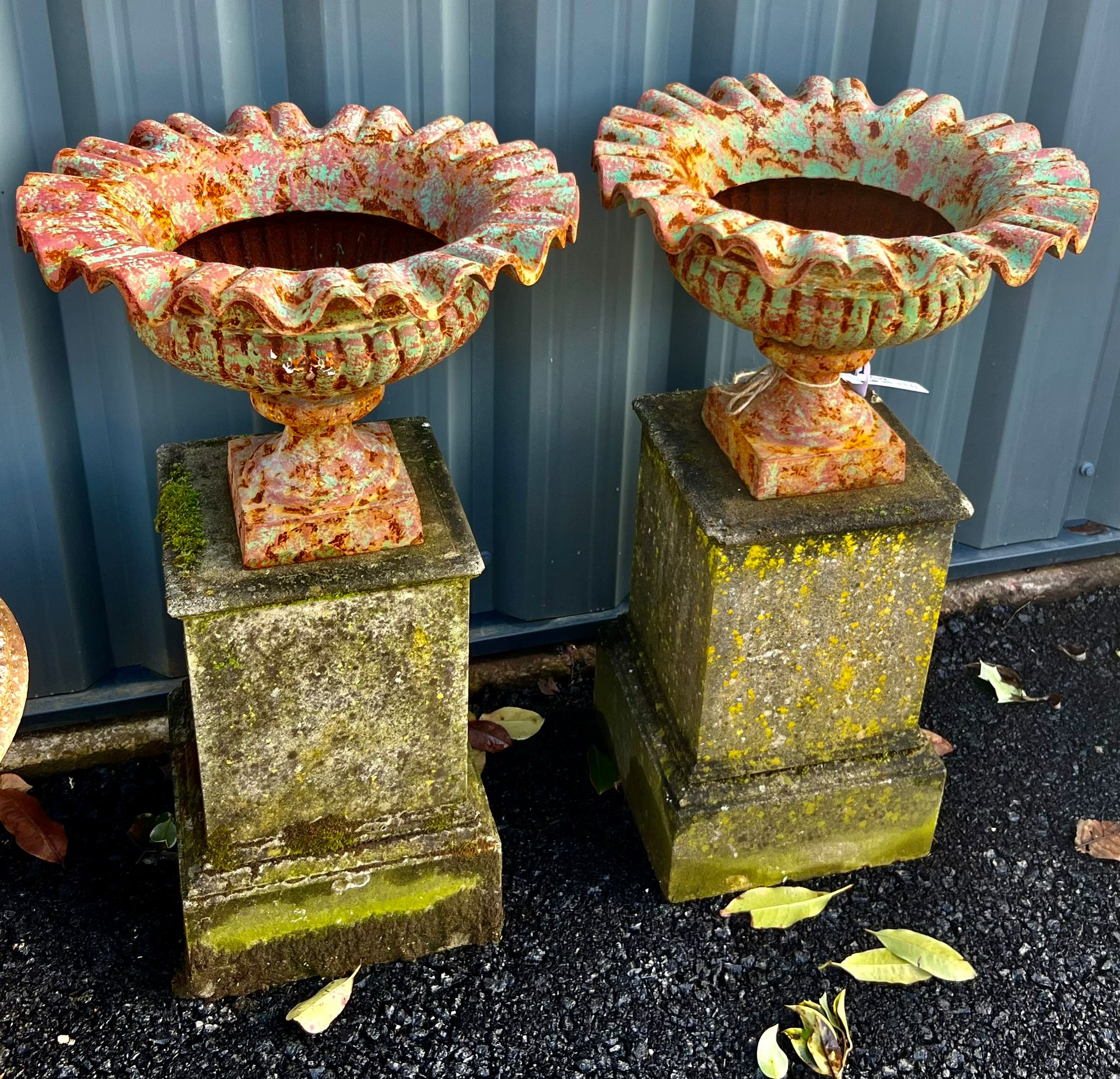 Antique Cast Iron Ruffled Edge Urns on Stone Plinths