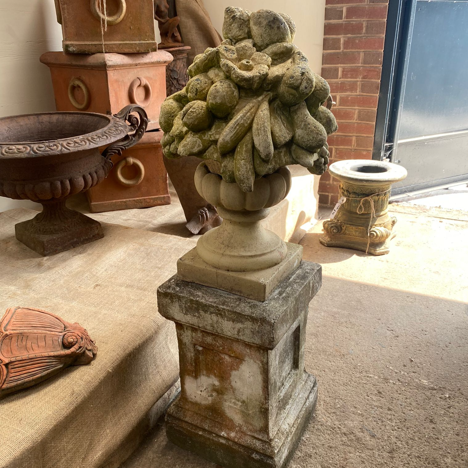 Stone Bowl of Fruit on Stone Plinth